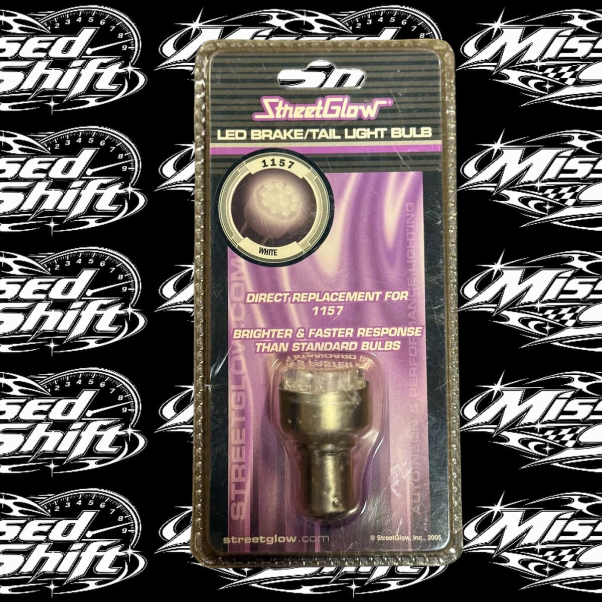 StreetGlow white LED 1157 brake and tail light bulb in original 2005 package on Missed Shift logo background